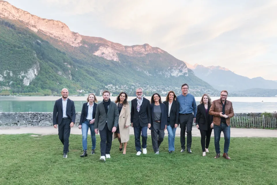 Équipe de professionnels au bord du lac avec les montagnes en arrière-plan